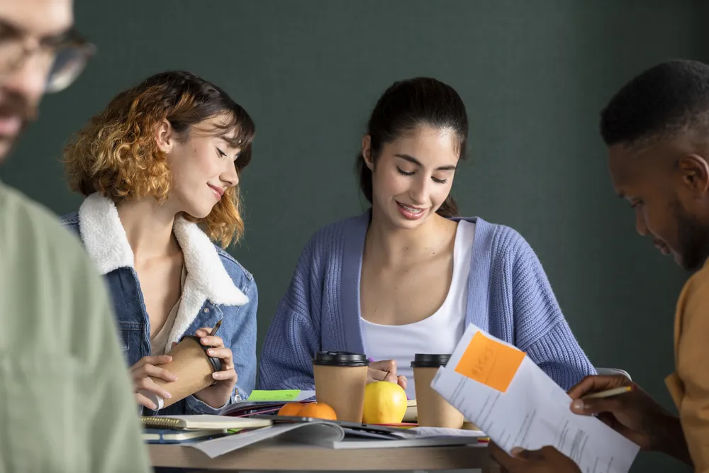 young-man-showing-his-friends-his-notes-study-session