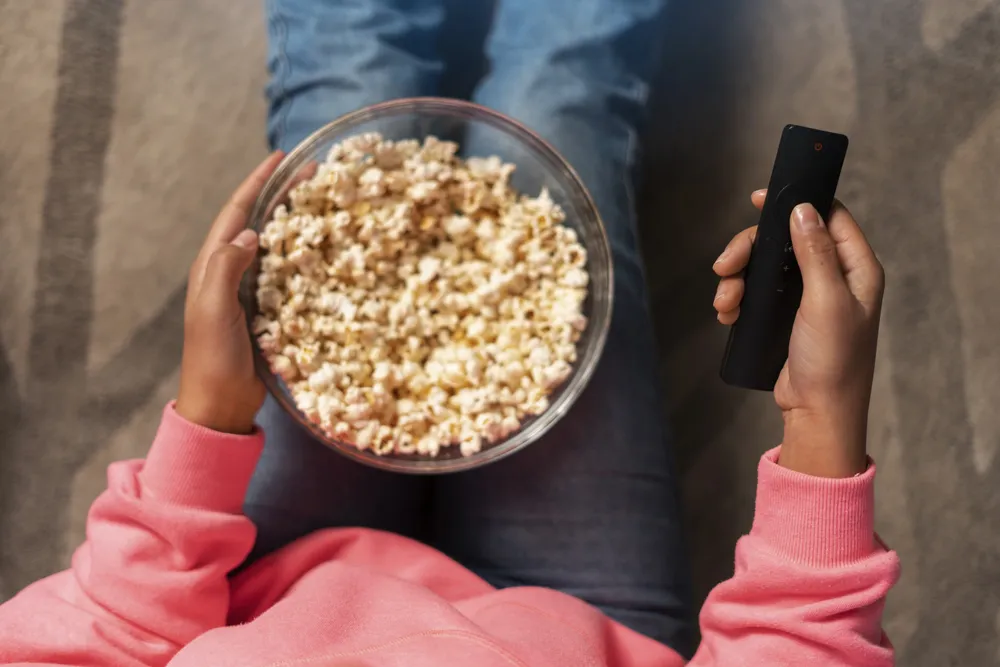 top-view-woman-holding-popcorn